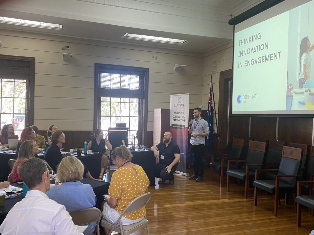 Dan Ferguson presenting the first public version of Communiti Analysis at Engage by the Beach in 2024, with Steven Germain seated beside him.